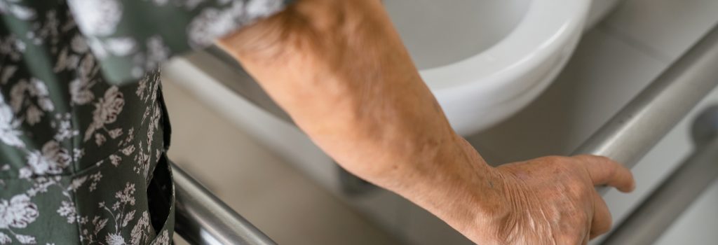 Asian elderly woman patient use toilet bathroom handle security in nursing hospital, healthy strong medical concept.