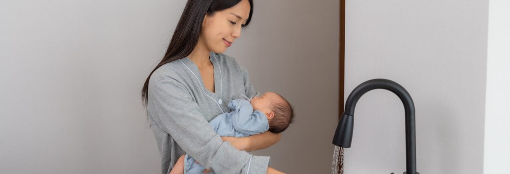 Asian woman take care her son and wash the baby accessory